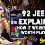 A digitally illustrated woman dressed in an Egyptian-inspired outfit stands beside a smartphone displaying the 92 Jeeto gaming platform. The background is filled with floating dice and golden confetti. The bold text reads: "92 Jeeto Explained – How It Works & Is It Worth Playing?" with the 92 Jeeto logo at the bottom.
